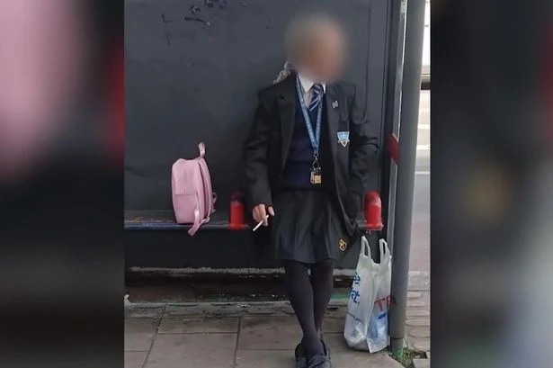Man dressed in schoolgirl uniform with pink bag near school as kids 'not safe'