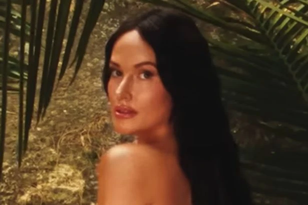 Chart-topping singer undresses in jungle and grabs boobs for saucy video