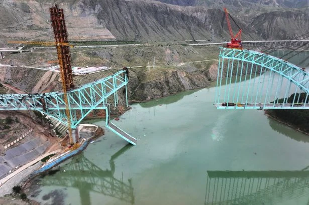 At least 12 people dead as railway bridge collapses after cable snaps