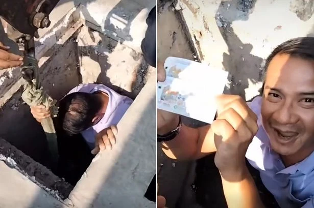 Crane operator lowers bloke into manhole to retrieve lost winning lotto ticket