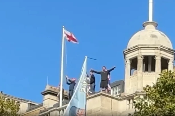 Tommy Robinson supporters scale building and chant his name as London protests turn violent