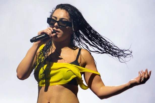 Charli XCX soaking wet in teeny boxers and little else as as crop top slips off