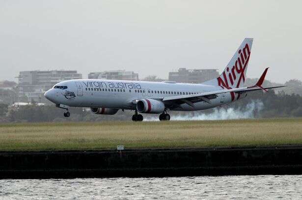 Passenger plane bursts into flames in mid-air as people watch on in horror