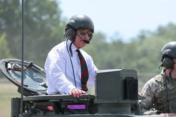 King Charles hops in a battle tank after 'withdrawing' Prince Harry's Palace invite