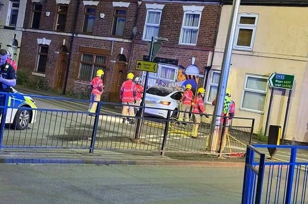 Horror as Tesla ploughs into UK house in late-night smash as rubble scattered over road