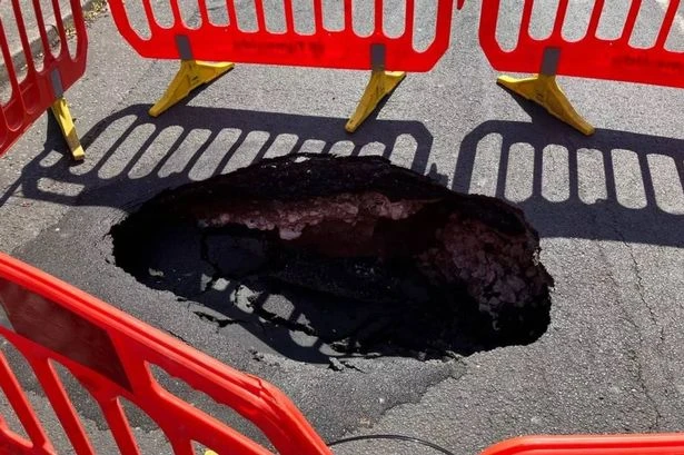 Huge sinkhole opens up and forces road closure as locals say 