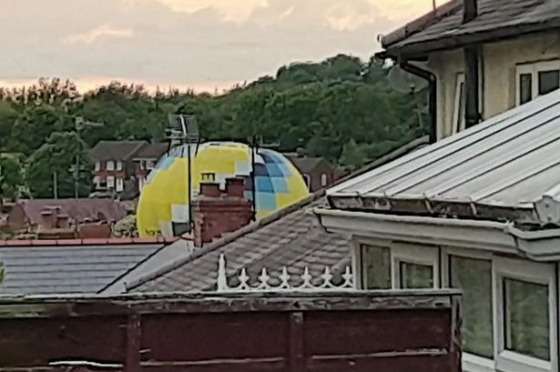 Moment hot air balloon misses target and lands in housing estate