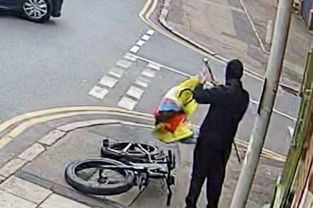 Moment yob rips down beauty salon's Pride flag in broad daylight as cars pass by