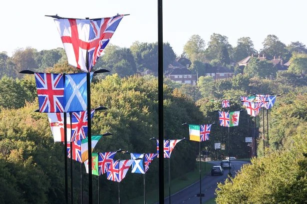 Group use cherry picker to erect over 40 flags on lampposts along entire Birmingham street