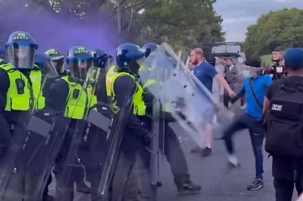Protesters clash with police outside hotel housing asylum seekers