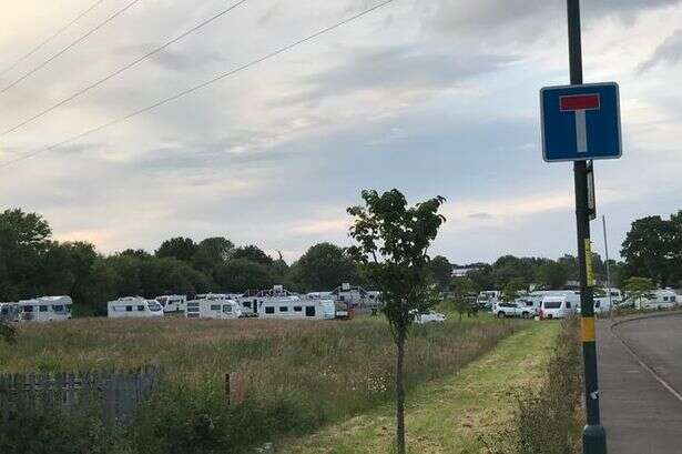 30 caravans surround city park's basketball court with camp yards from primary school