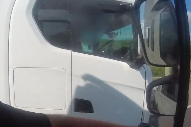 Watch M5 trucker roll cigarette with no hands on wheel as police go undercover in HGV