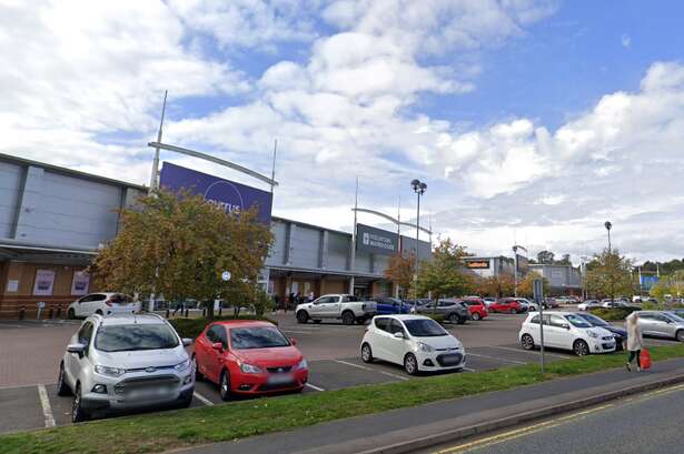 Man arrested after elderly woman hit by delivery van on retail park