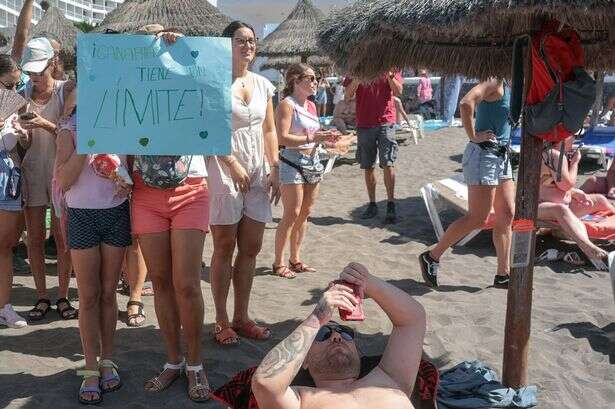 Tourists' defiant act as Tenerife locals storm beach and shout 'go home'