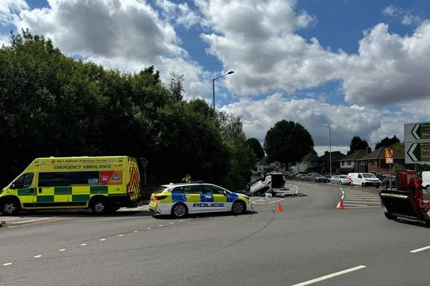 Three people injured after car overturns on busy Midlands road