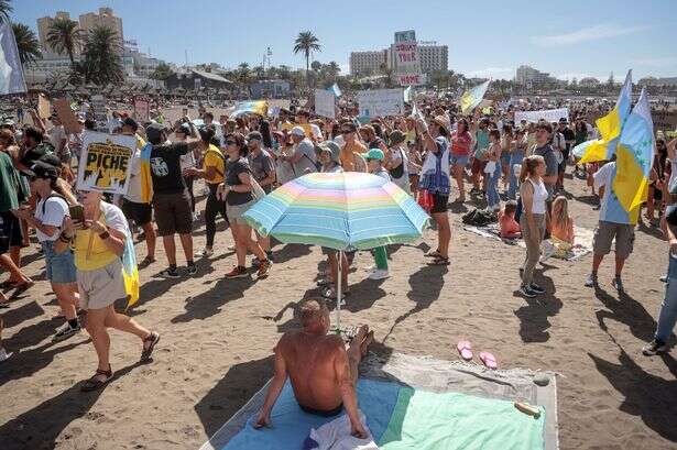 'Anti tourism' protests spread across Spain's islands with sunbathing Brits targeted on beach