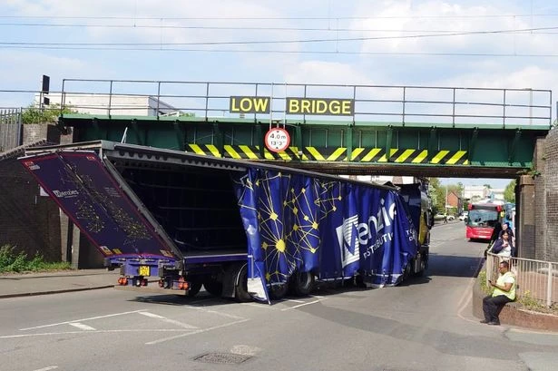 Trains disrupted and road closed after lorry strikes Black Country railway bridge