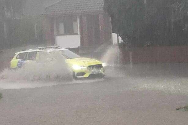 Moment deluge sweeps West Midlands village leaving car 'stranded'